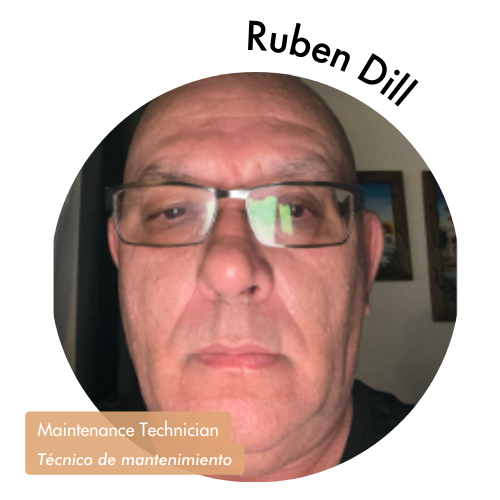 Pictured is a circle shaped image of Ruben Dill. Ruben is looking into the camera and wears dark, rectangular glasses. His name is on the upper right in bold black letters curving around the image. On the bottom left, his position title is written in white text and highlighted in a medium tan color. His position title is, "Maintenance Technician, Técnico de mantenimiento."