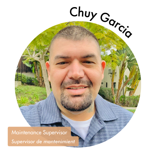 Pictured is a circle shaped image of Chuy Garcia. Chuy is smiling with short hair and greenery in the background. His name is on the upper right in bold black letters curving around the image. On the bottom left, his position title is written in white text and highlighted in a medium tan color. His position title is, "Maintenance Supervisor, Supervisor de mantenimiento"