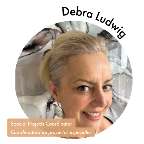 Pictured is a circle shaped image of Debra Ludwig. Debra is has blonde hair with a marble background behind her. Her name is on the upper right in bold black letters curving around the image. On the bottom left, her position title is written in white text and highlighted in a medium tan color. Her position title is, "Special Projects Coordinator, Coordinadora de proyectos especiales"